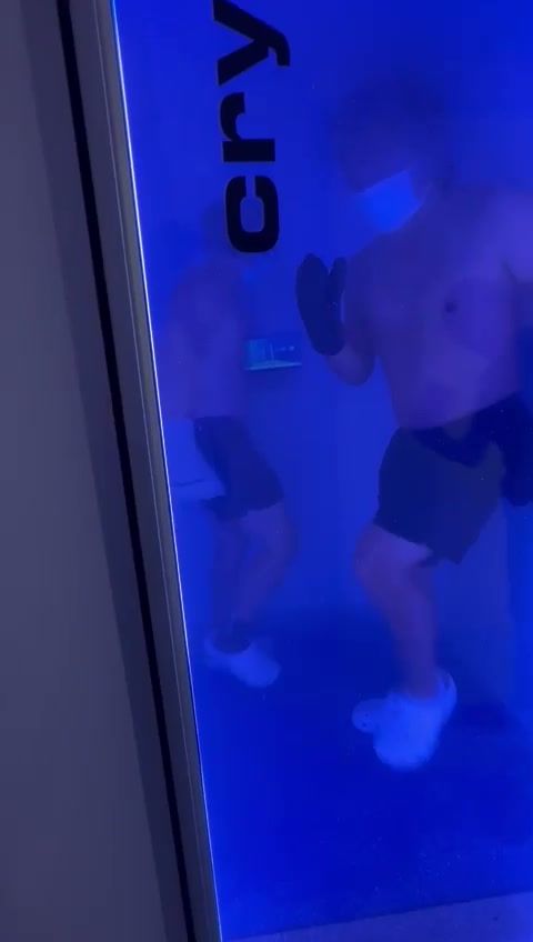 Two guests inside the blue-lit whole-body cryotherapy chamber at The Longevity Science Centrum.