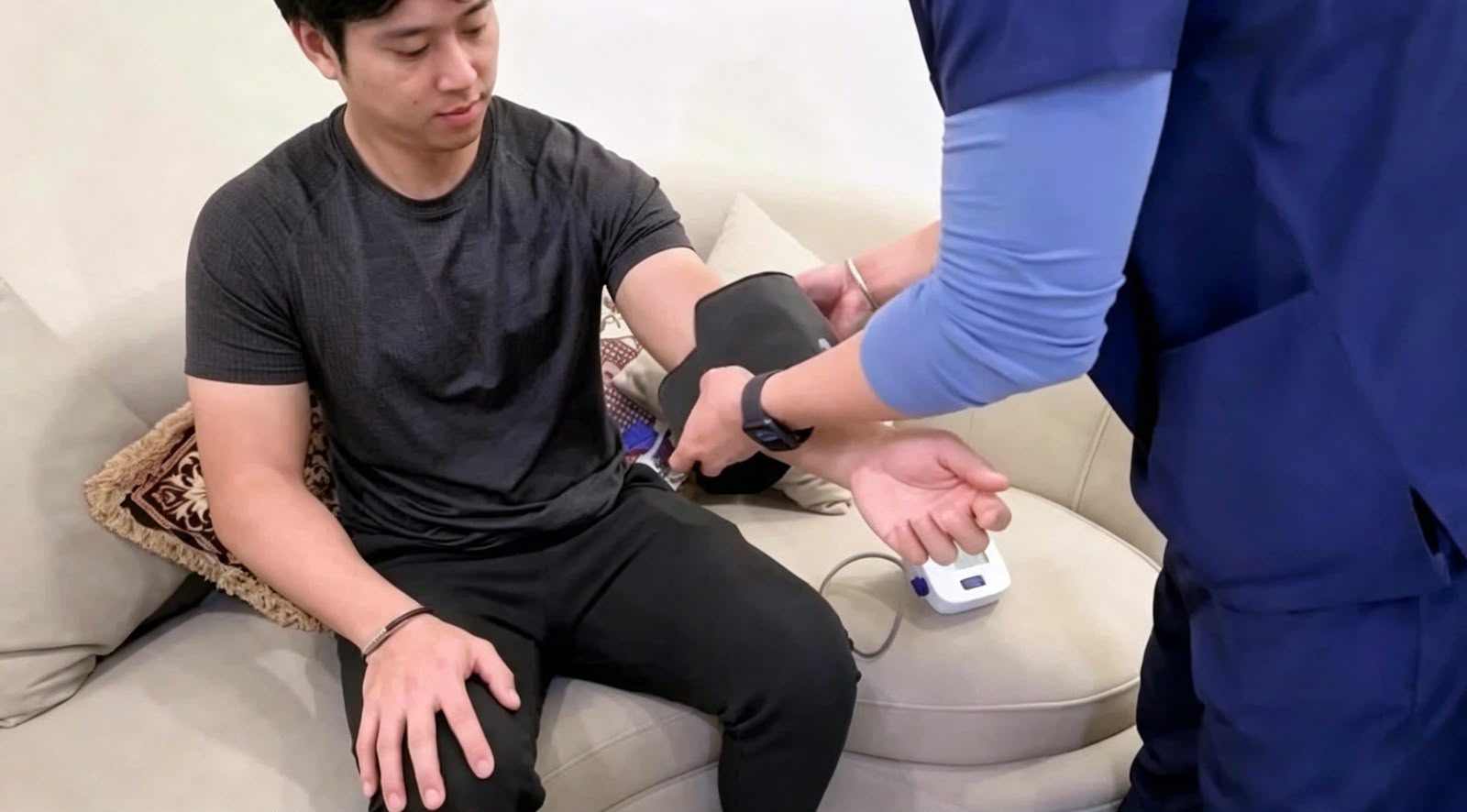 A team member at The Longevity Science Centrum taking Jonathan Kim-Moss's blood pressure during his visit.